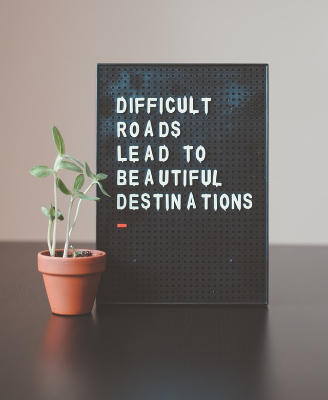 A sign that says difficult roads lead to beautiful destinations.