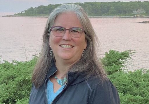 A woman standing in front of the water.