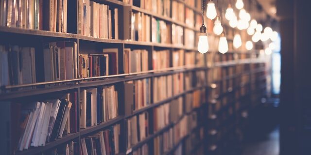 A library filled with lots of books and lights.